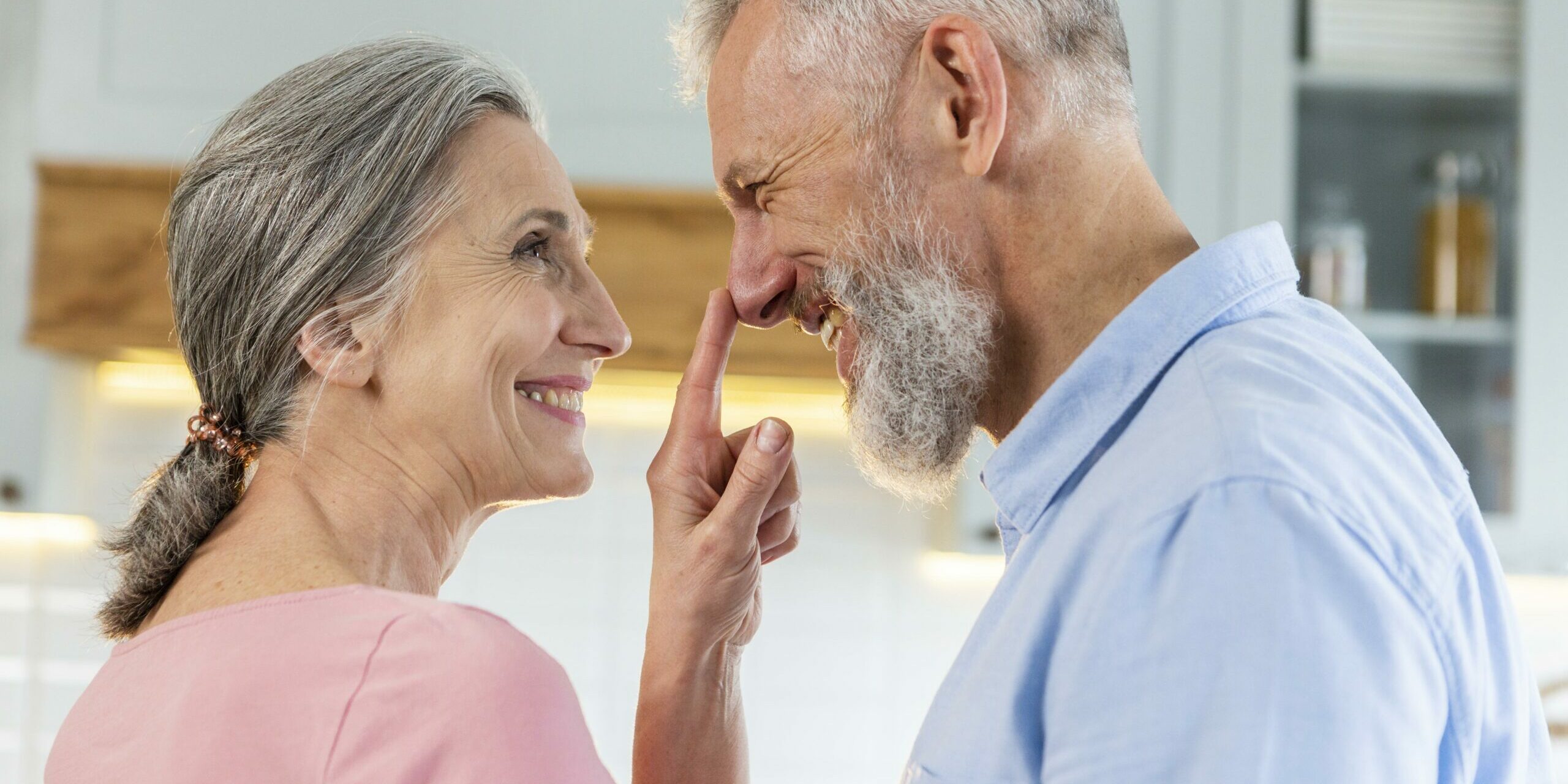 Pärchen lächelt sich an und sie tippt auf seine Nase